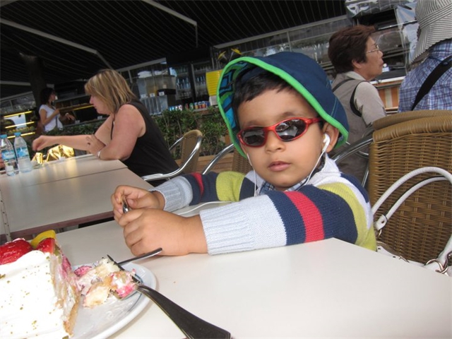 Adi eating cake and enjoying music